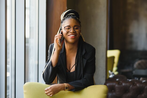 Young woman in a cafe with a smartphone