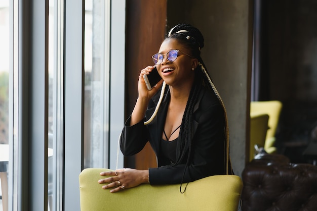 Young woman in a cafe with a smartphone