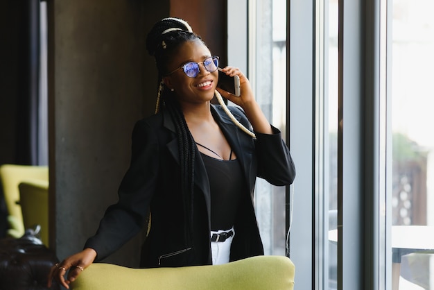 Young woman in a cafe with a smartphone