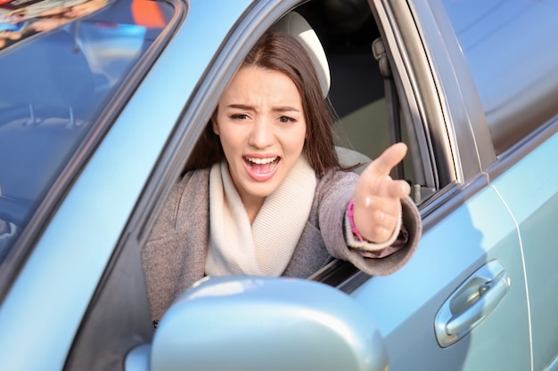 Young woman in car during traffic jam