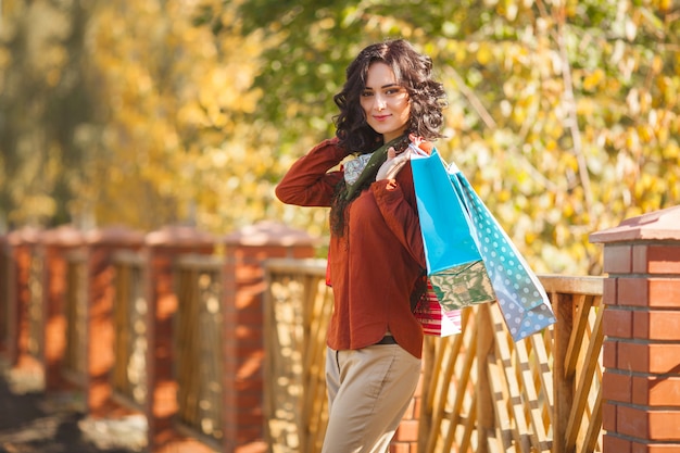 Young woman carrying shopping bags.