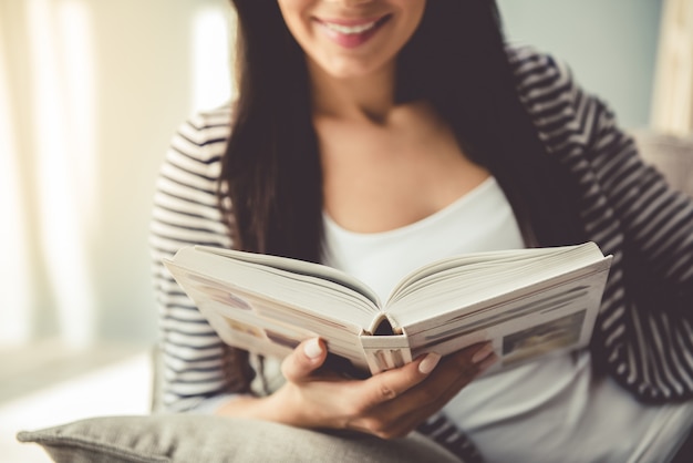 Young woman in casual clothes reading a book