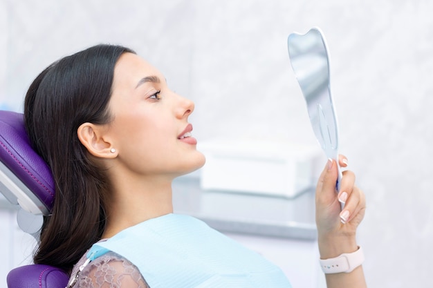 Young woman checks her teeth