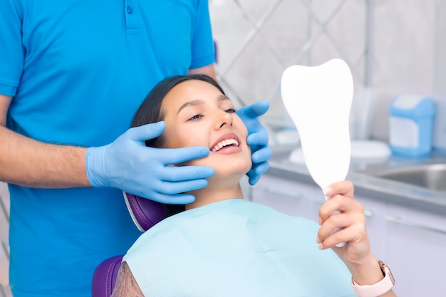 Young woman checks her teeth