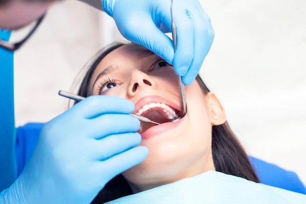 Young woman checks her teeth