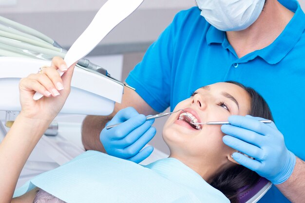 Young woman checks her teeth