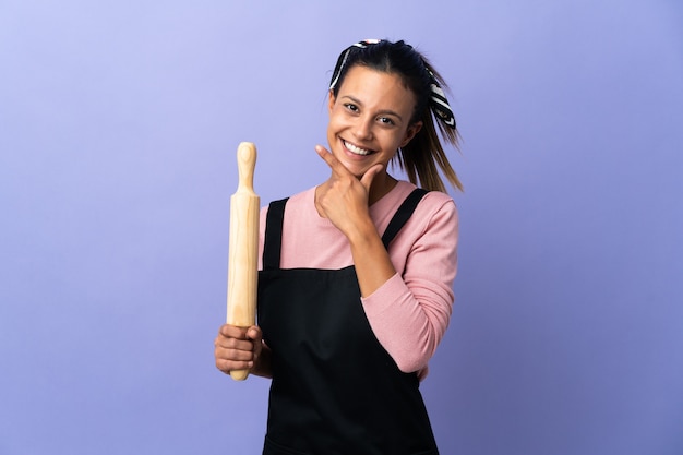 Young woman in chef uniform happy and smiling