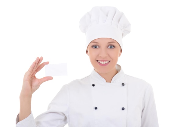 Young woman chef in uniform showing visiting card isolated on white