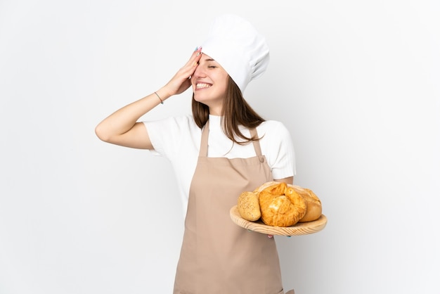 Young woman in chef uniform on white laughing