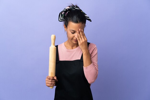 Young woman in chef uniform with tired and sick expression