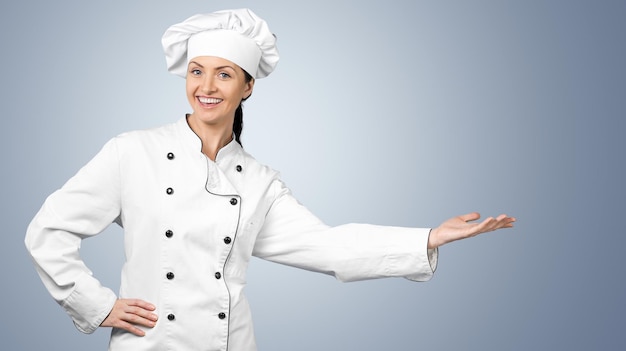 Young woman chef in white uniform