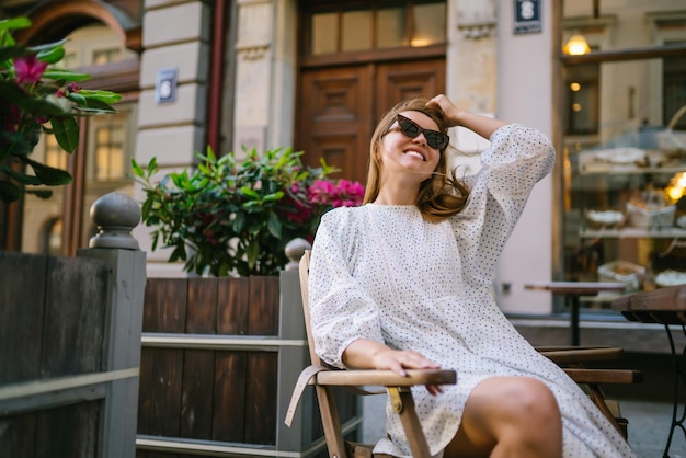 Young Woman chilling in cozy cafe looking around happy emotions Traveling woman