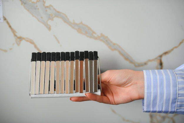 Young woman choosing ceramic tiles