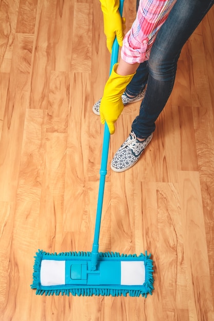 Young woman cleaning the floor