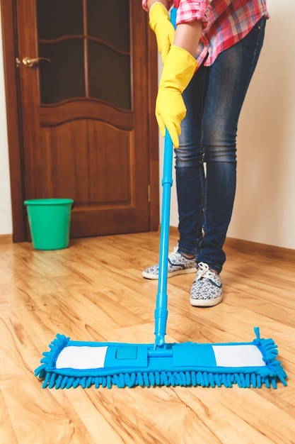 Young woman cleaning the floor