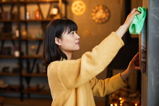 Young Woman Cleaning Home Side View