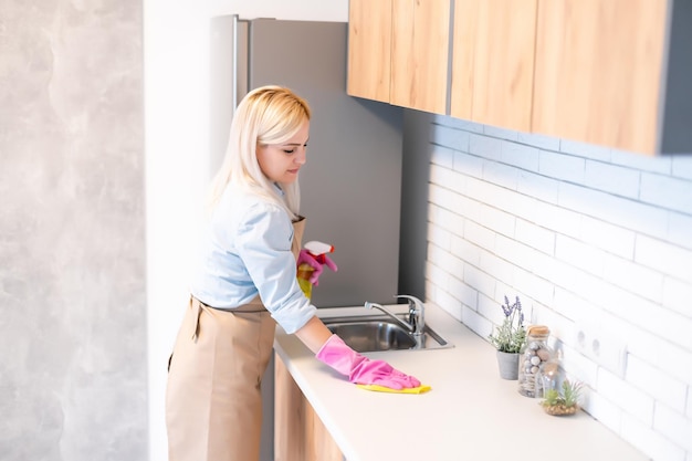 Young woman Cleaning Kitchen Cabinets