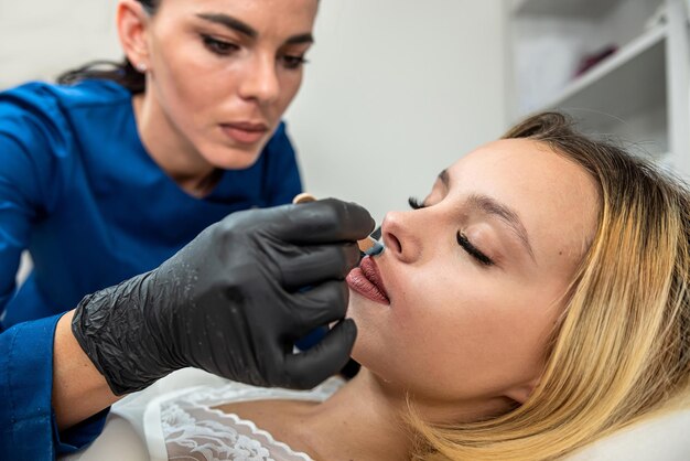 Photo young woman client get removing hair on the upper lip in face with hot sugar wax