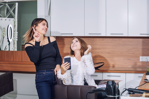 Young woman client makes a haircut and styling at a professional hairdresser in a beauty salon