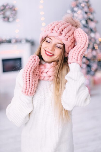 Young woman closed her eyes and smiles girl in stylish winter\
c