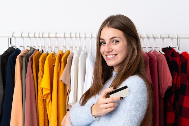 Young woman in a clothing store holding a credit card