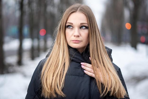 Young woman in a coat on the street