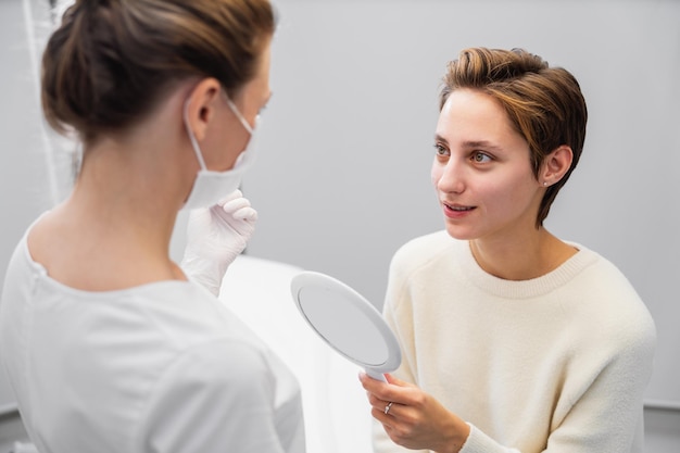 Молодая женщина консультируется с косметологом о ее лице фото высокого качества