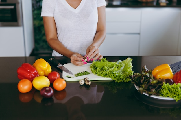 The young woman cooking in the kitchen