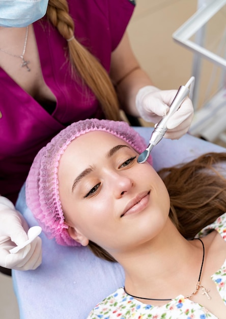 Young woman at cosmetologist. Cosmetology procedure. Skin and health care.