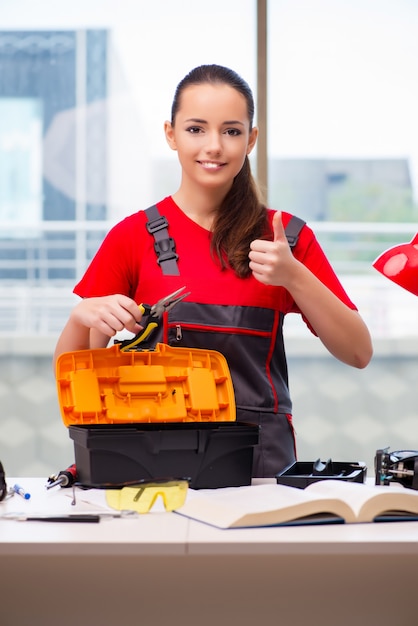 Young woman in coveralls doing repairs