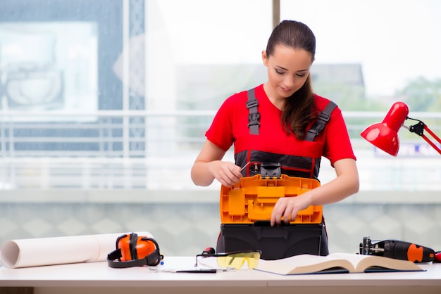 Young woman in coveralls doing repairs