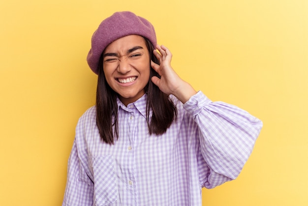 Young woman covering ears with hands.