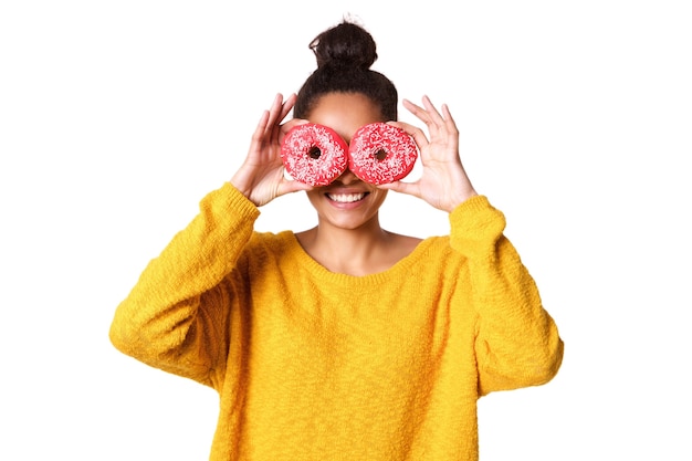 Young woman covering her eyes with donut