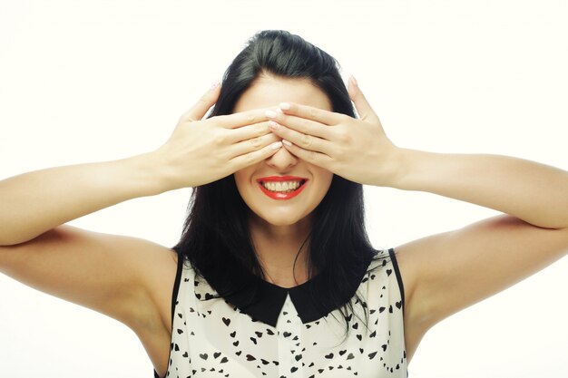 Young woman covering her eyes with her hands.