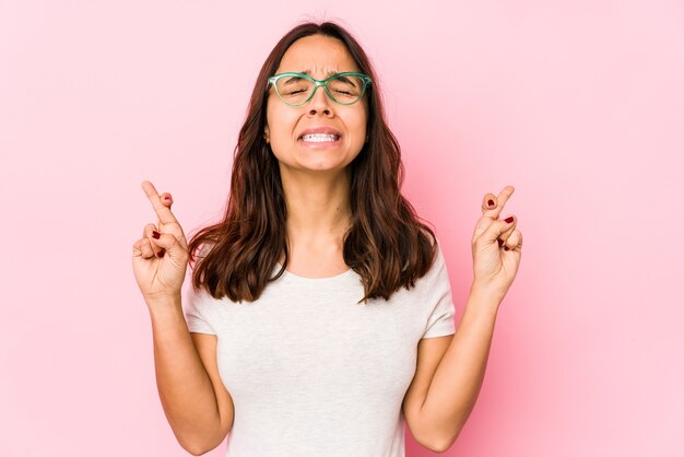 Young woman crossing fingers for having luck