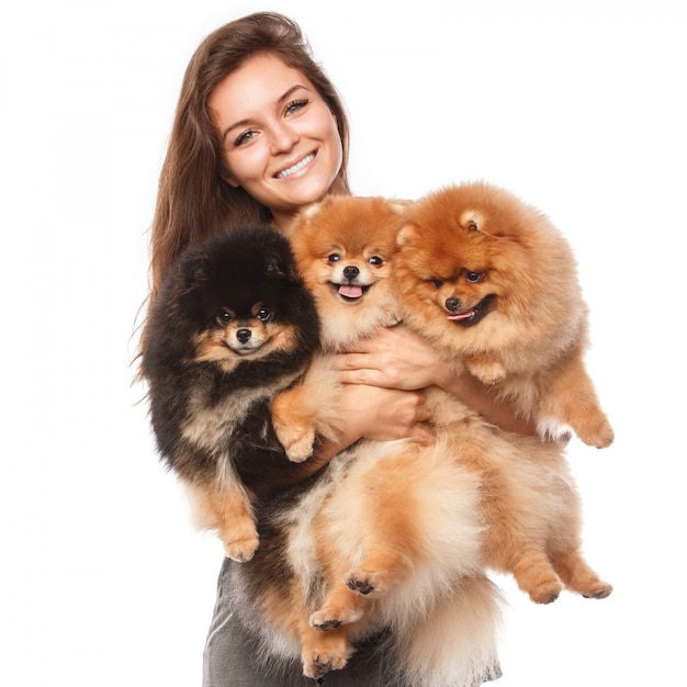 Young woman and cute spitz dogs