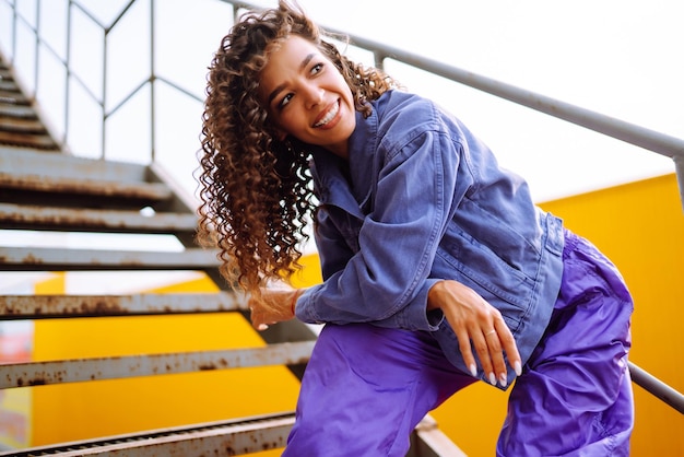 Young woman dancer with american bandana dancing in the street Sport dancing and urban culture