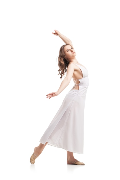 Young woman dancing in gorgeous white dress over white