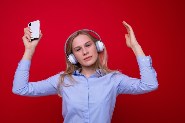 Young woman dancing to music from her phone