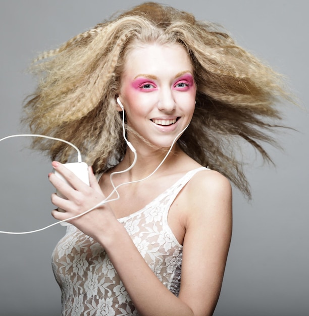 Young woman dancing to music on her headphones