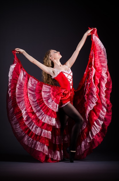 Young woman dancing in red dress