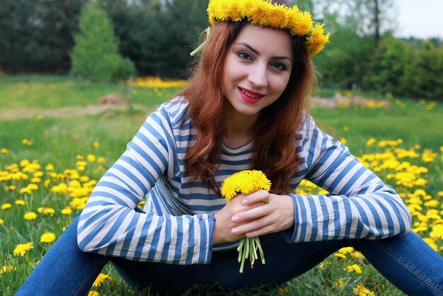 Young woman on dandelion meadow