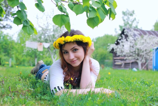 Young woman on dandelion meadow