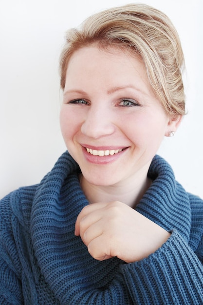 La giovane donna con il maglione blu scuro sorride