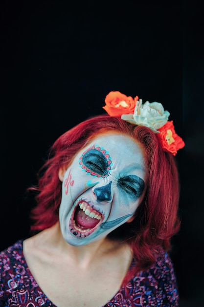 A young woman in day of the dead mask skull face art.