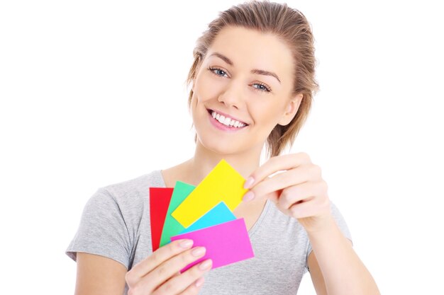 a young woman deciding on colors over white background