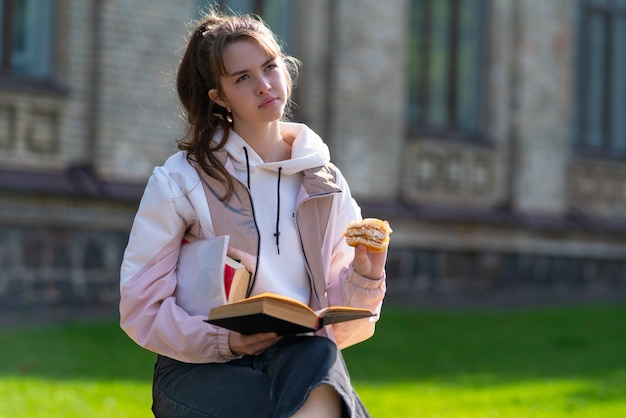 Young woman deep in thought sitting studying