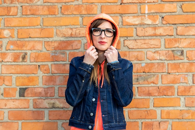 Young woman in a denim jacket and glasses