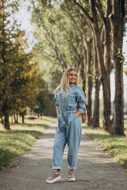 Young woman in denim jumpsuit