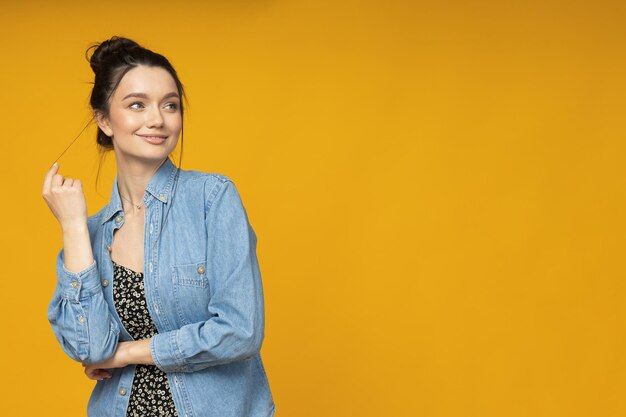 Young woman in a denim shirt hair tied up